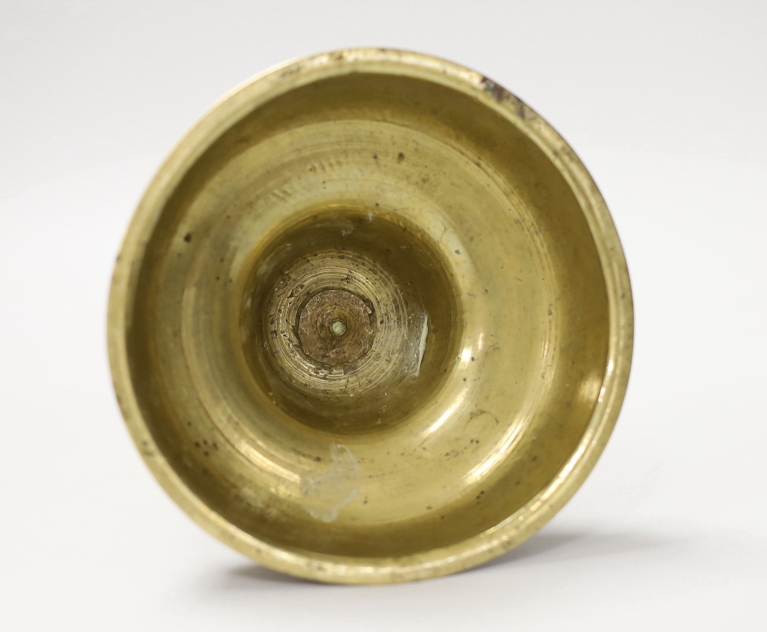 A 17th century continental brass candlestick. 28cm high